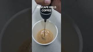 Nescafe gold coffee preparation using Rainbow evapurated milk.Mixing by hand held milk mixer